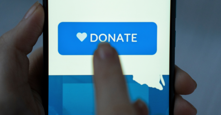 Women holding phone and pressing blue donate button